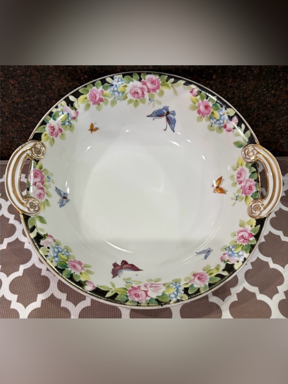 Nippon Hand-painted bowl featuring a floral motif & butterflies with gold trim